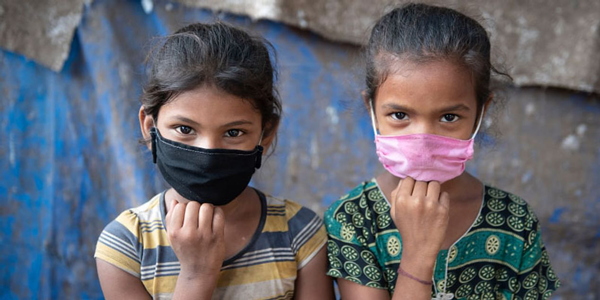 two girls wearing face masks